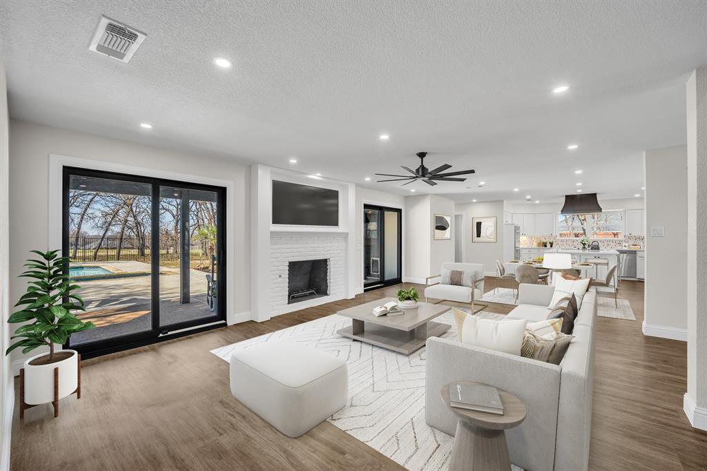 7004 Ledbetter Road Arlington, TX 76001 - Photo 10 of 39 a living room with furniture a fireplace and a potted plant