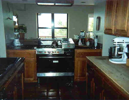 4210 Christy Way Reno, NV 89519 - Photo 1 of 3 a kitchen with stainless steel appliances granite countertop a stove a sink and a microwave