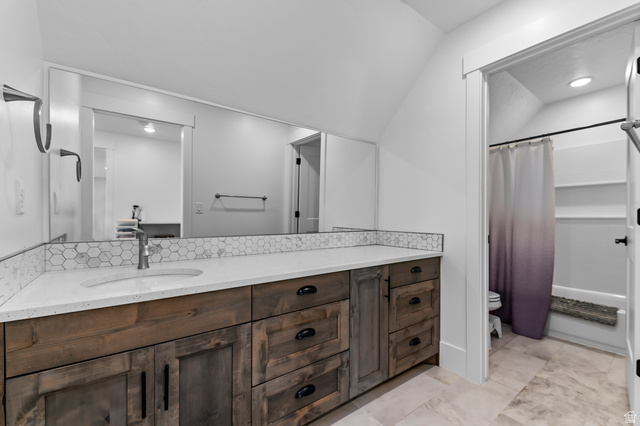 1426 South 1450th Street West Mapleton, UT 84664 - Photo 43 of 50 Bathroom vanity featuring a quartz countertop, integrated sink, and wood-finish cabinetry with dark hardware
