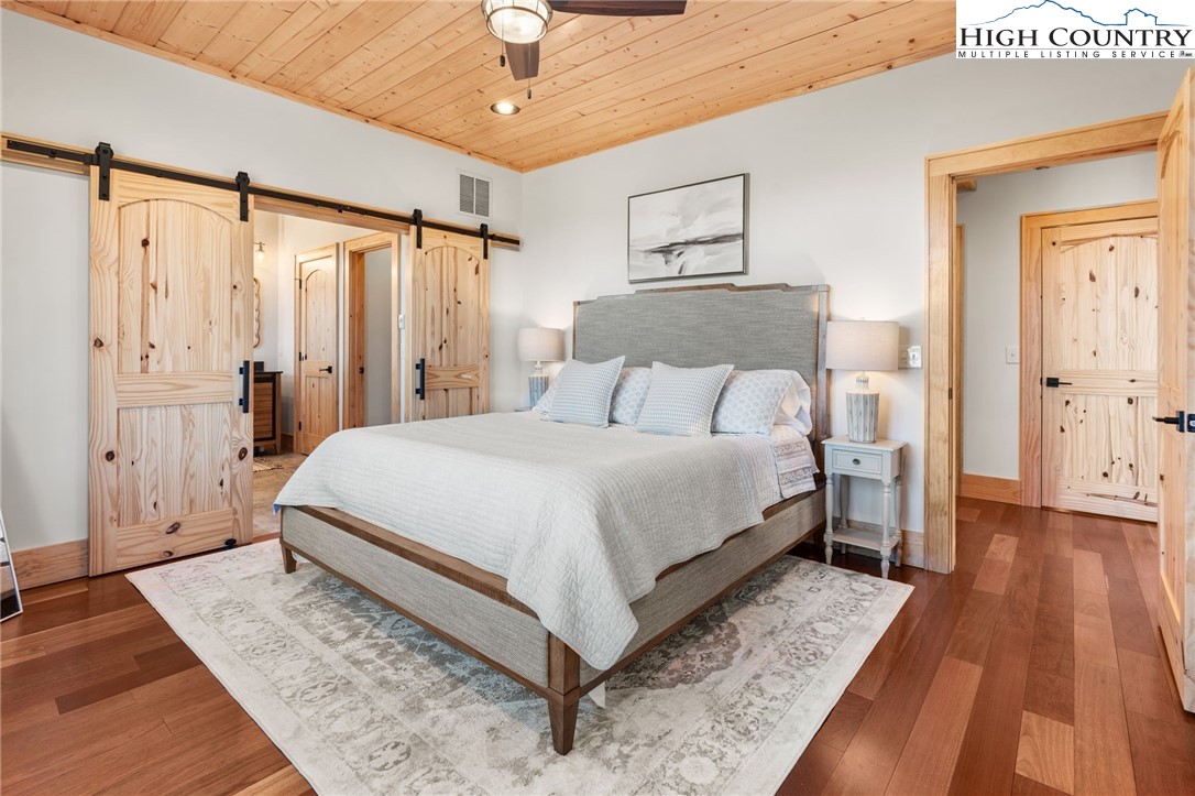 171 Pleasant View Vilas, NC 28692 - Photo 19 of 49 a bedroom with a bed and wooden floor