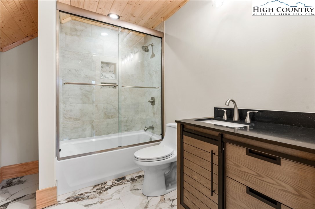 171 Pleasant View Vilas, NC 28692 - Photo 25 of 49 a bathroom with a granite countertop sink toilet and shower