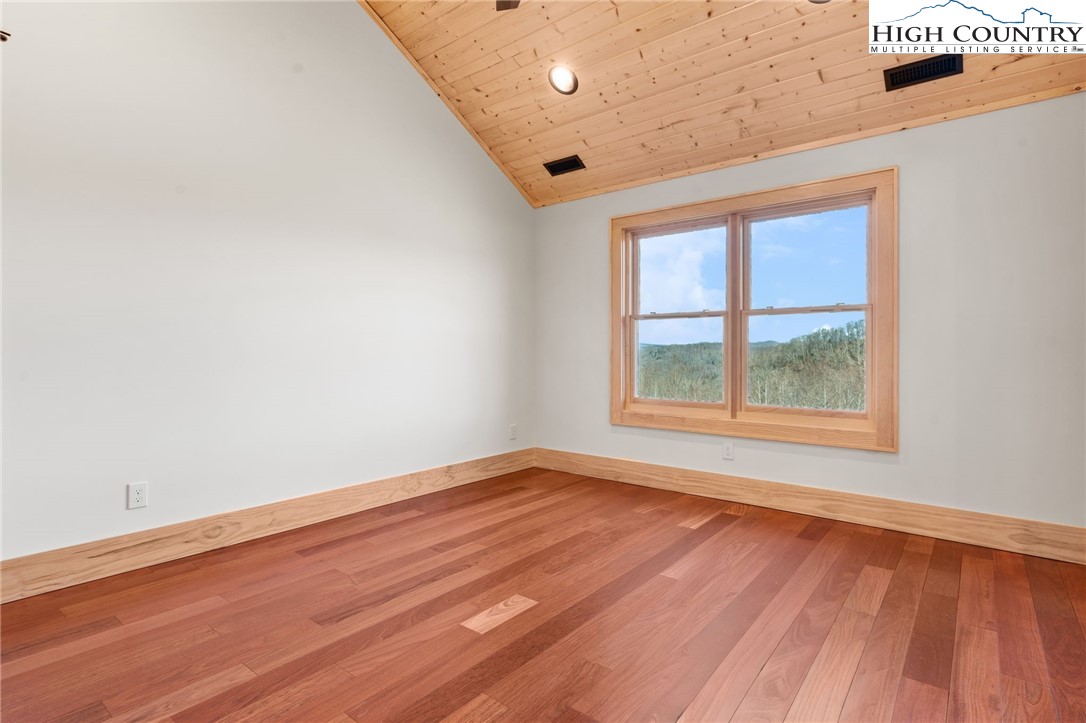 171 Pleasant View Vilas, NC 28692 - Photo 26 of 49 an empty room with wooden floor and windows