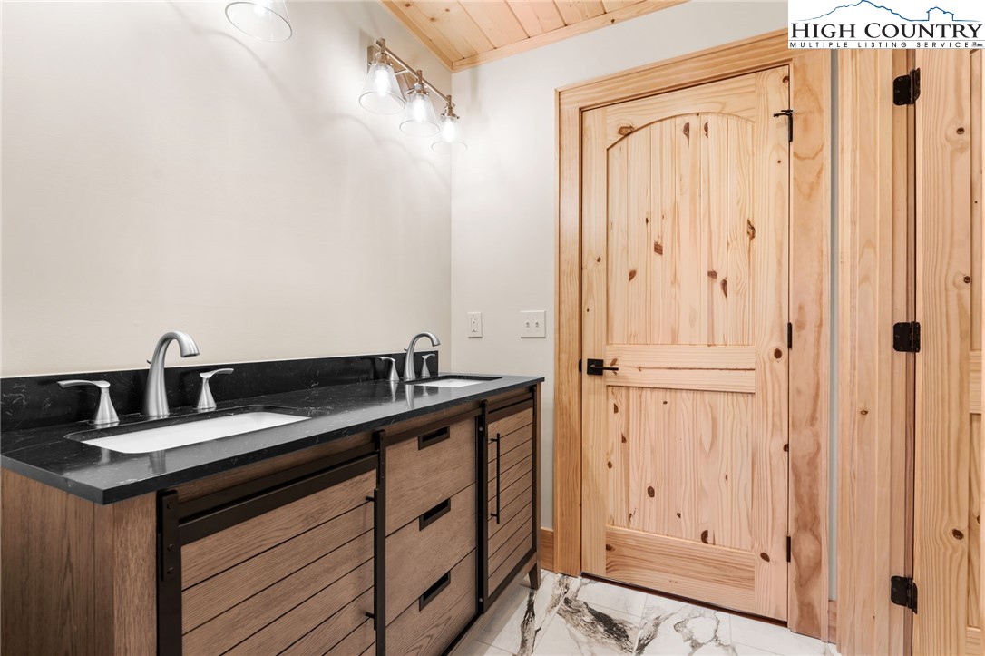 171 Pleasant View Vilas, NC 28692 - Photo 28 of 49 a bathroom with a sink and a mirror