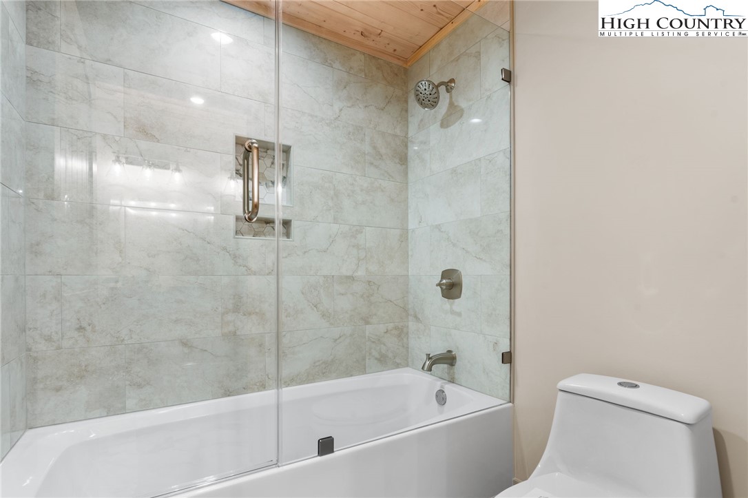 171 Pleasant View Vilas, NC 28692 - Photo 29 of 49 a bathroom with a bathtub and a toilet