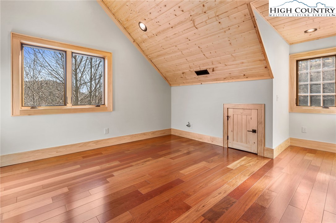 171 Pleasant View Vilas, NC 28692 - Photo 35 of 49 a view of an empty room with wooden floor and a window