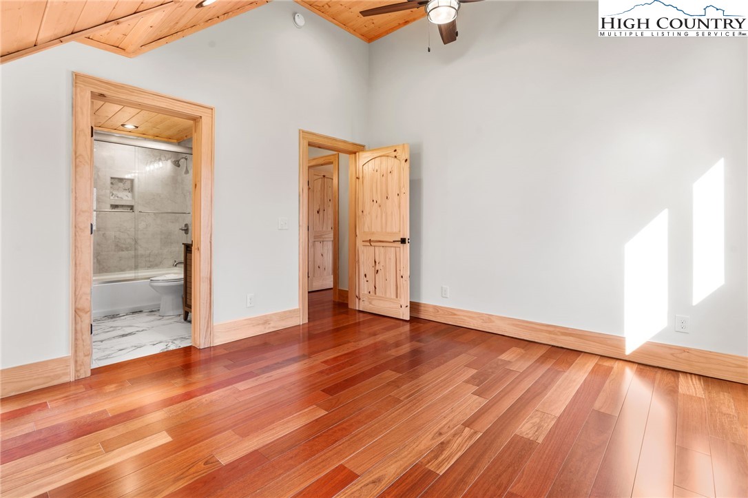 171 Pleasant View Vilas, NC 28692 - Photo 36 of 49 an empty room with wooden floor and door