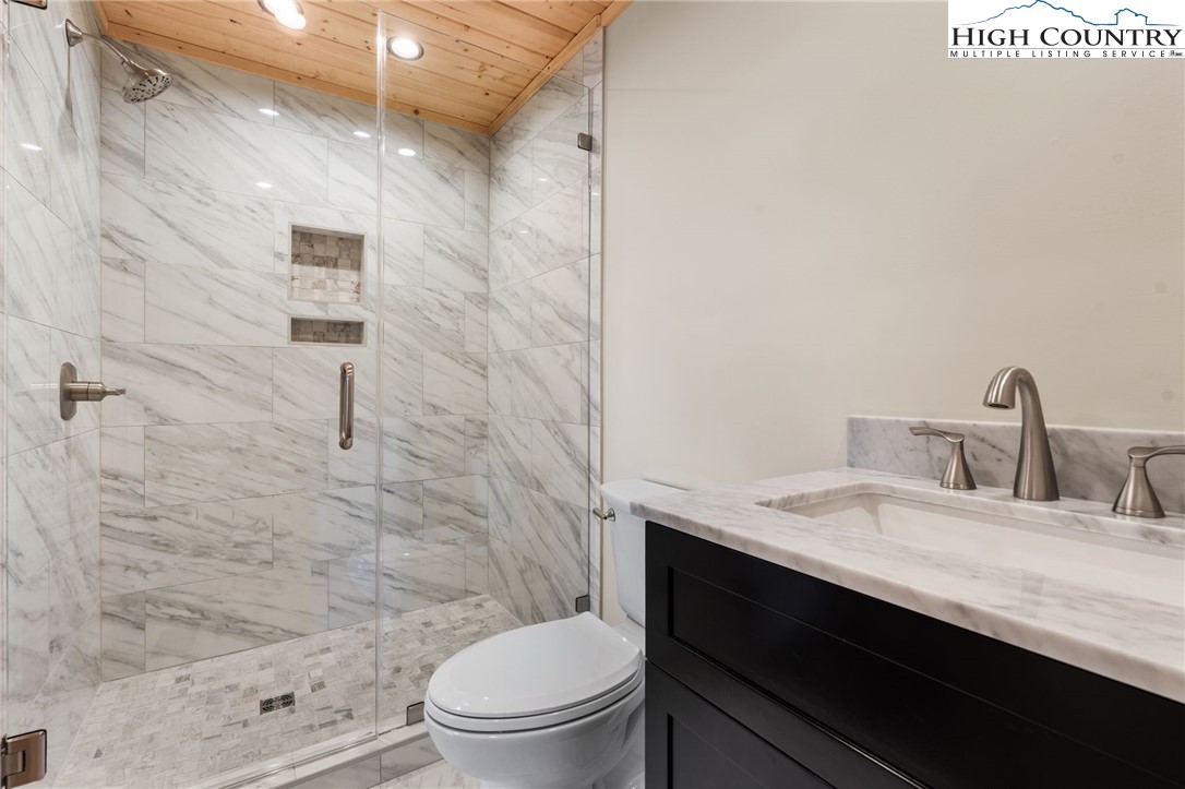 171 Pleasant View Vilas, NC 28692 - Photo 42 of 49 a bathroom with a sink a toilet and shower