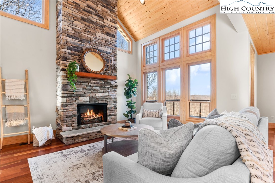 171 Pleasant View Vilas, NC 28692 - Photo 6 of 49 a living room with furniture a fireplace and a large window