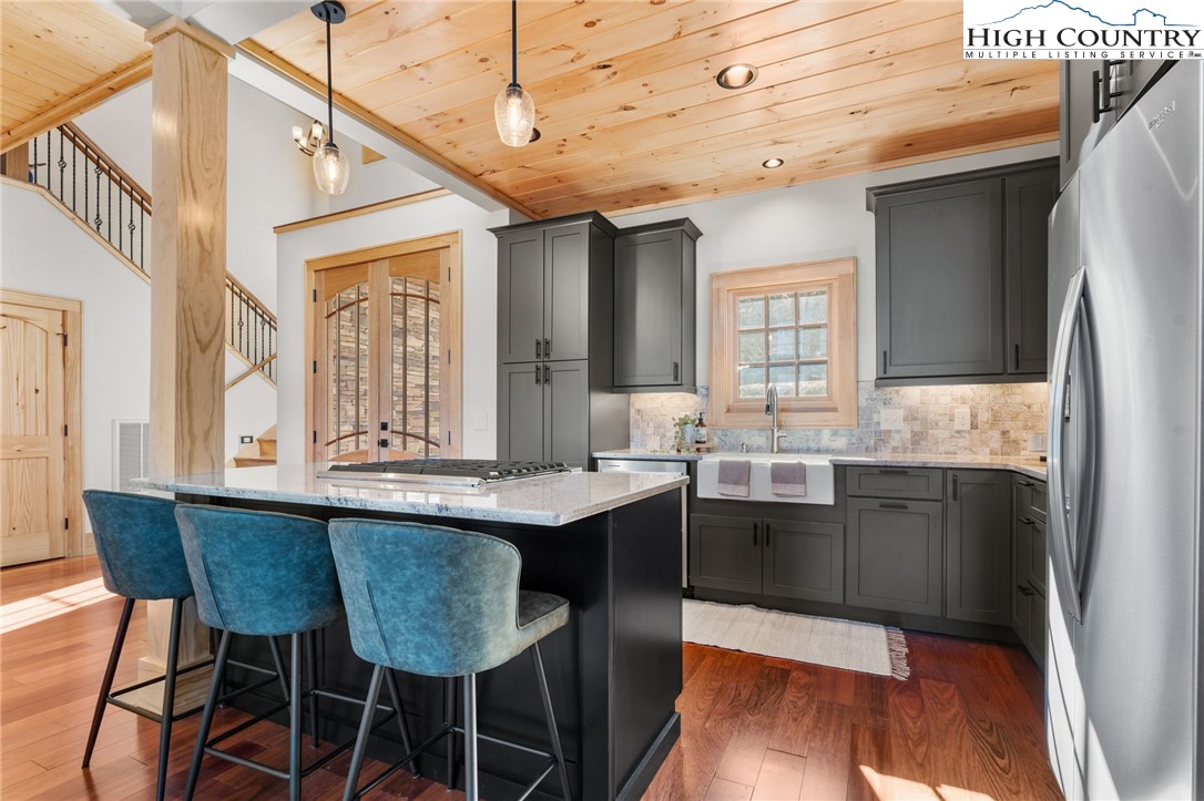 171 Pleasant View Vilas, NC 28692 - Photo 9 of 49 a dining hall with stainless steel appliances granite countertop a sink and wooden floor