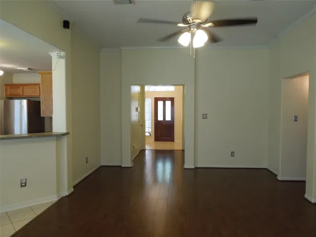 a view of empty room with wooden floor