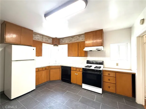 a kitchen with stainless steel appliances granite countertop a sink and a stove