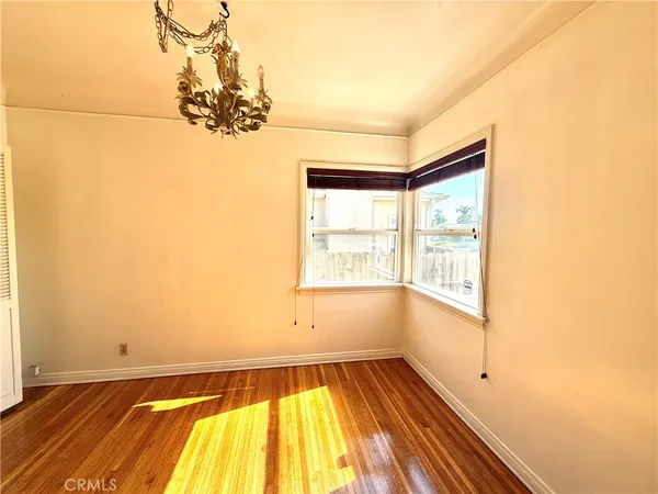 a view of a room with wooden floor and window