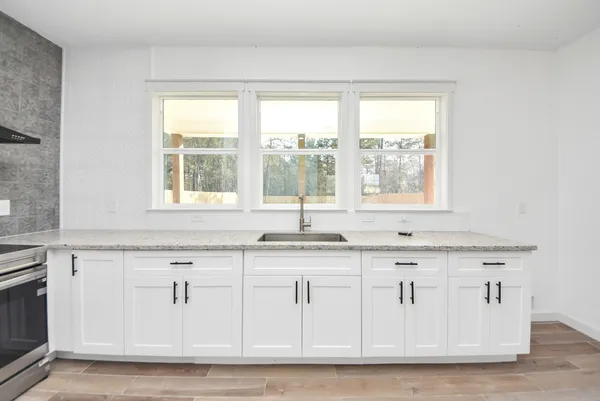 a kitchen with a stove and a window