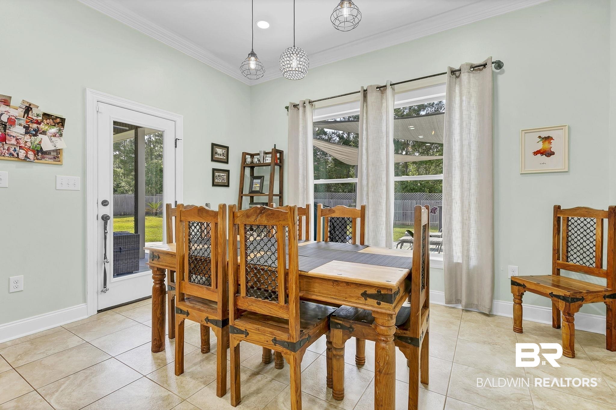 30635 Drayton Court Daphne, AL 36527 - Photo 19 of 51 Dining area featuring ornamental molding, healthy amount of natural light, light tile patterned flooring, and baseboards