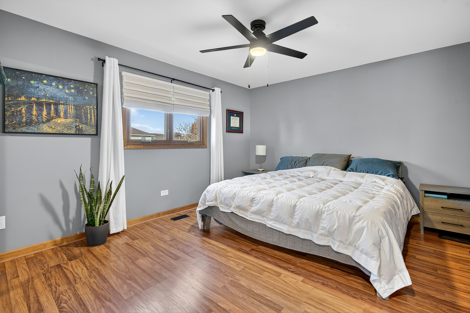 7800 Brunswick Road Darien, IL 60561 - Photo 11 of 33 a bedroom with a large bed and a chandelier