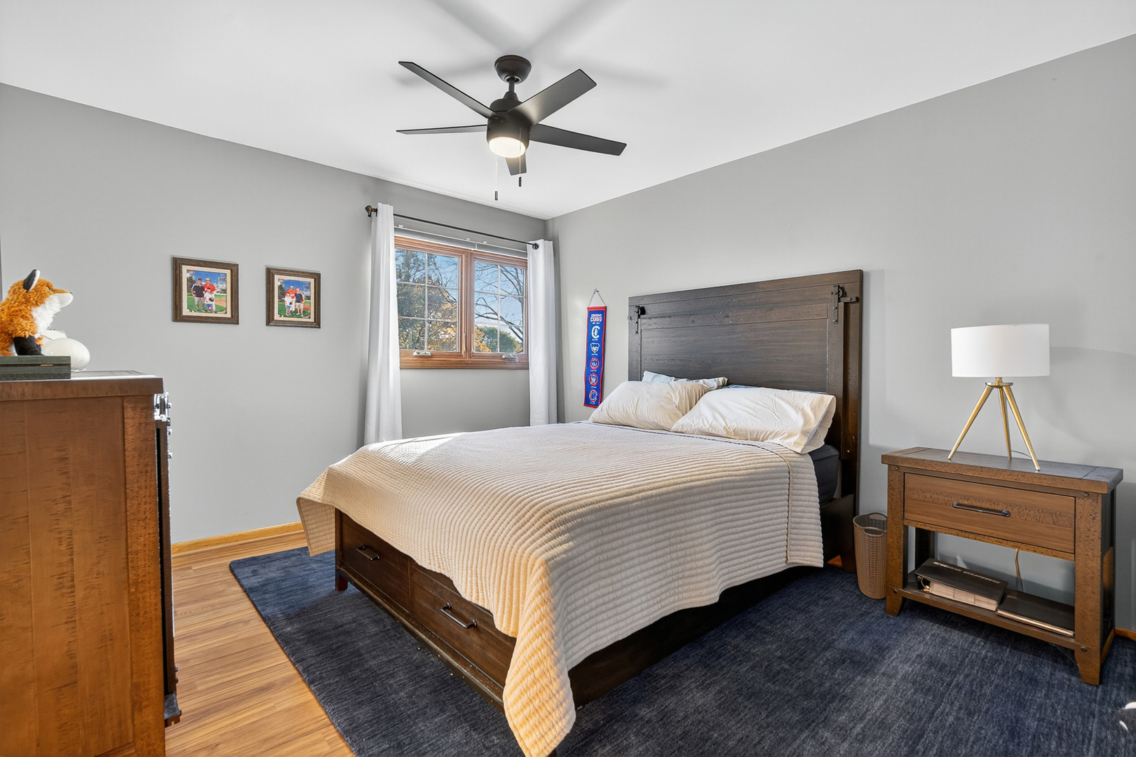 7800 Brunswick Road Darien, IL 60561 - Photo 15 of 33 a bedroom with a bed and a chandelier