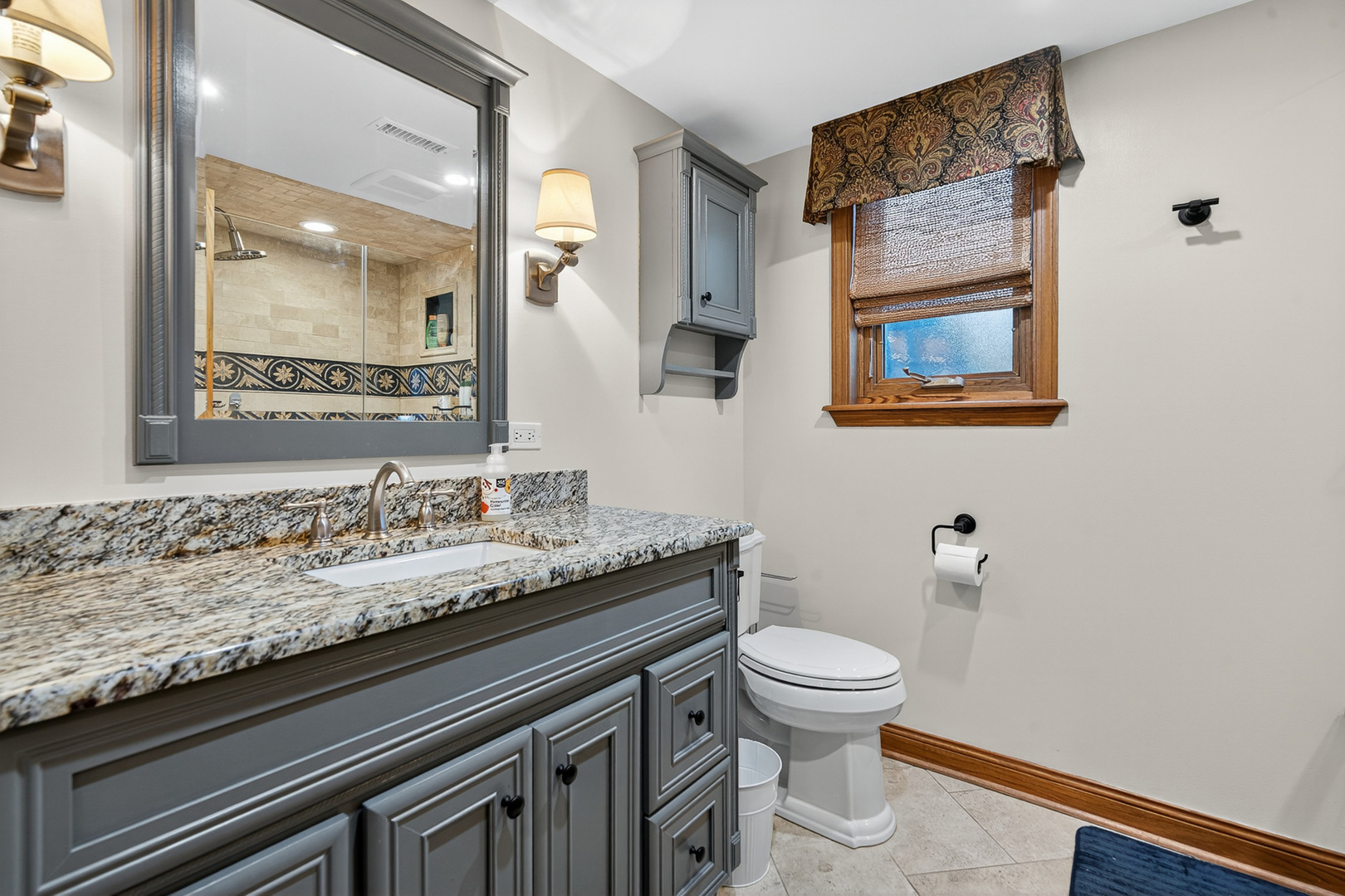 7800 Brunswick Road Darien, IL 60561 - Photo 20 of 33 a bathroom with a granite countertop sink a toilet and mirror