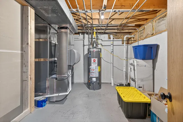 a view of a room with water heater and storage