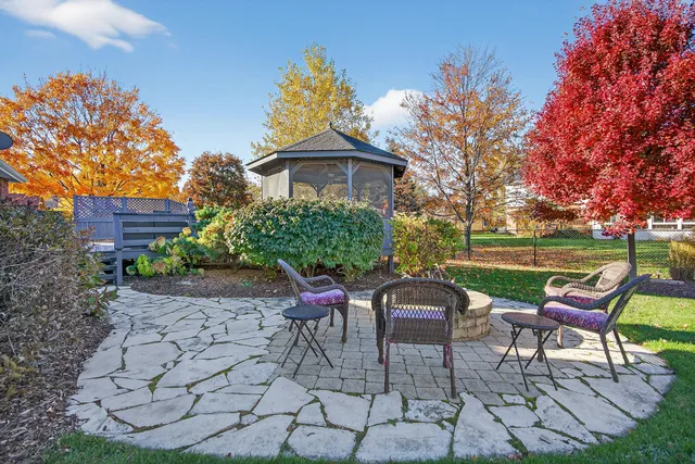 a view of a chairs and table in backyard