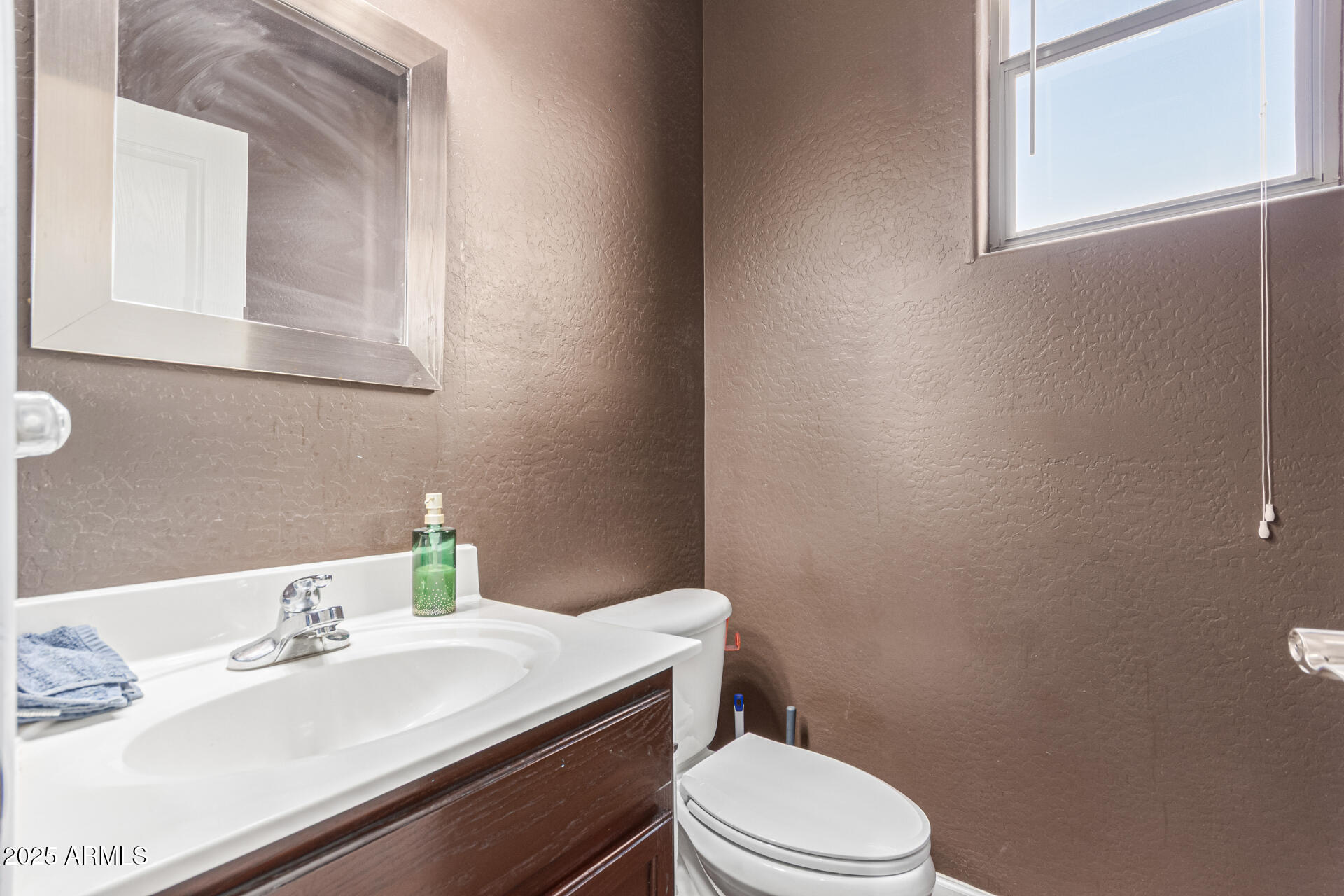 3802 East Chickadee Road Gilbert, AZ 85297 - Photo 12 of 29 a bathroom with a sink a toilet and mirror