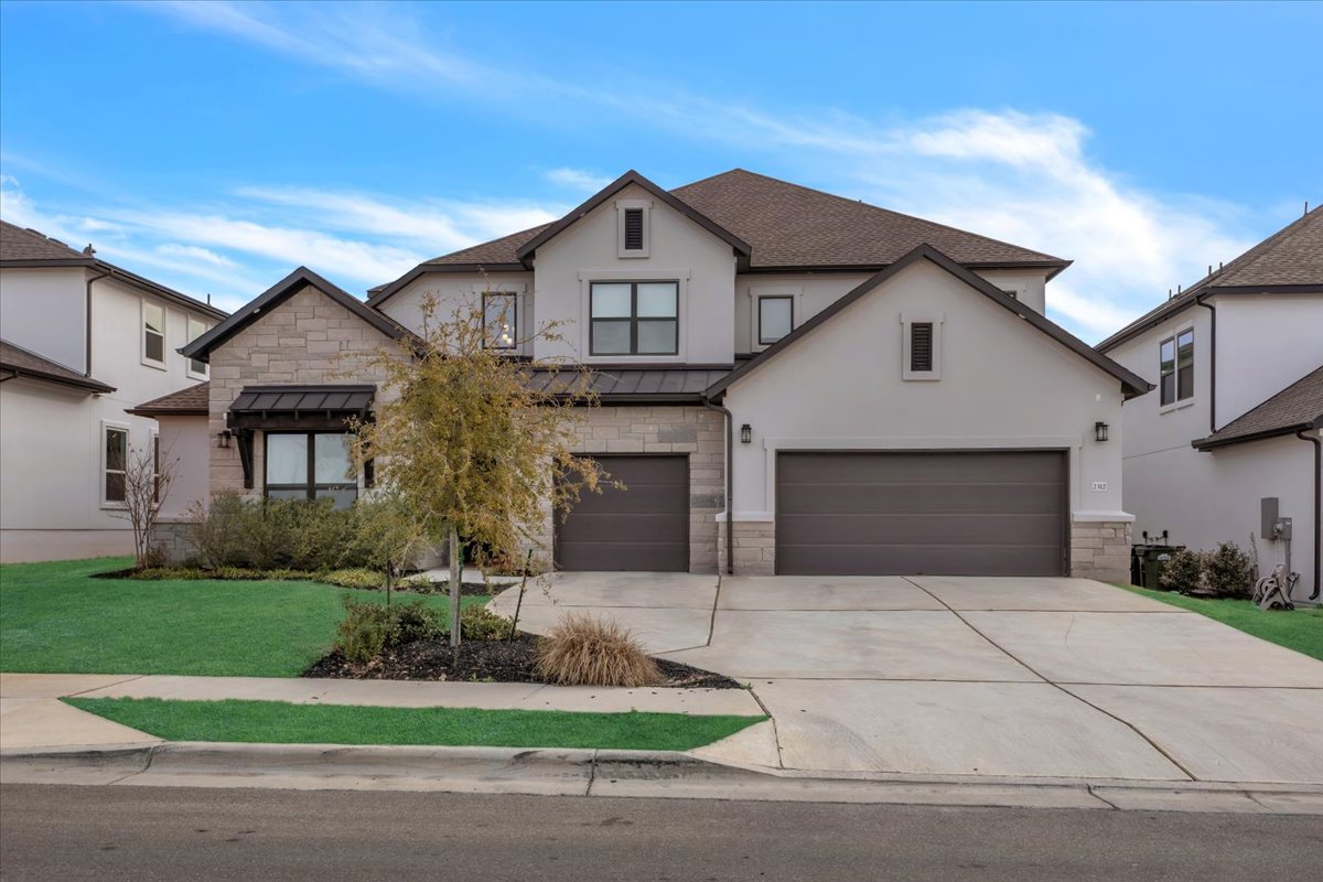 2312 Mondello Path Leander, TX 78641 - Photo 1 of 40 a front view of a house with a yard and garage