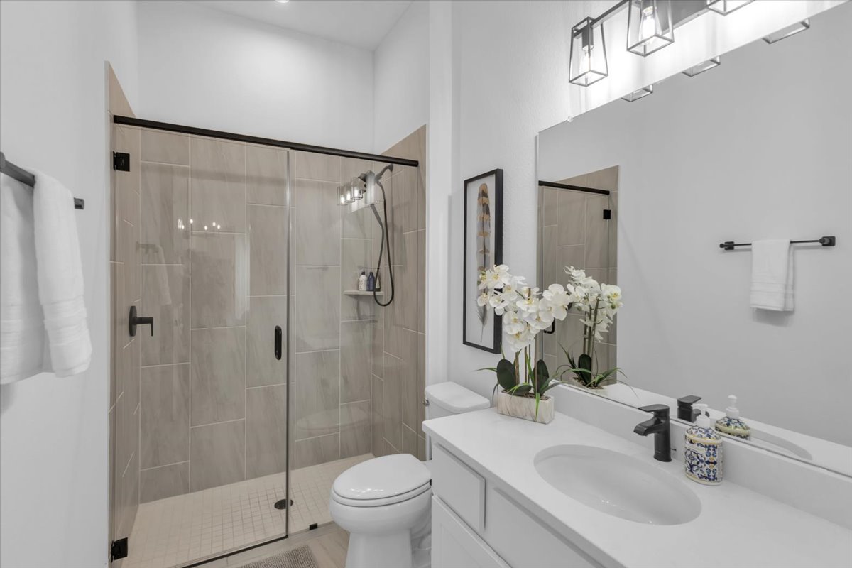 2312 Mondello Path Leander, TX 78641 - Photo 11 of 40 a bathroom with a sink toilet and shower