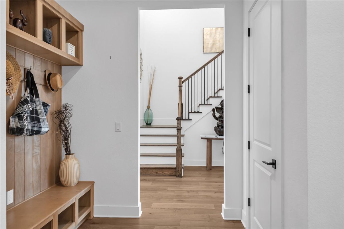 2312 Mondello Path Leander, TX 78641 - Photo 14 of 40 a view of hallway with stairs and wooden floor