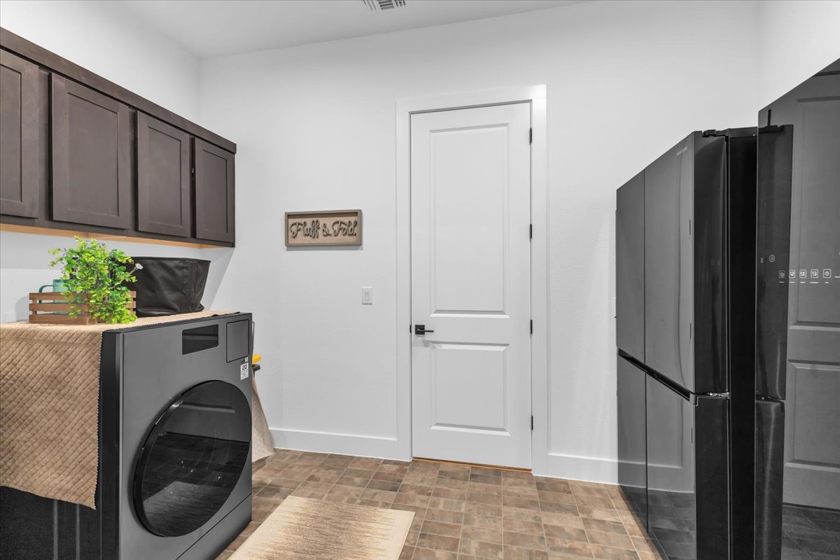 2312 Mondello Path Leander, TX 78641 - Photo 15 of 40 a utility room with closet dryer and washer