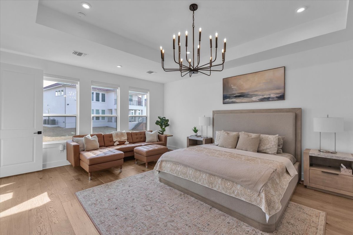 2312 Mondello Path Leander, TX 78641 - Photo 16 of 40 a bedroom with bed and a chandelier