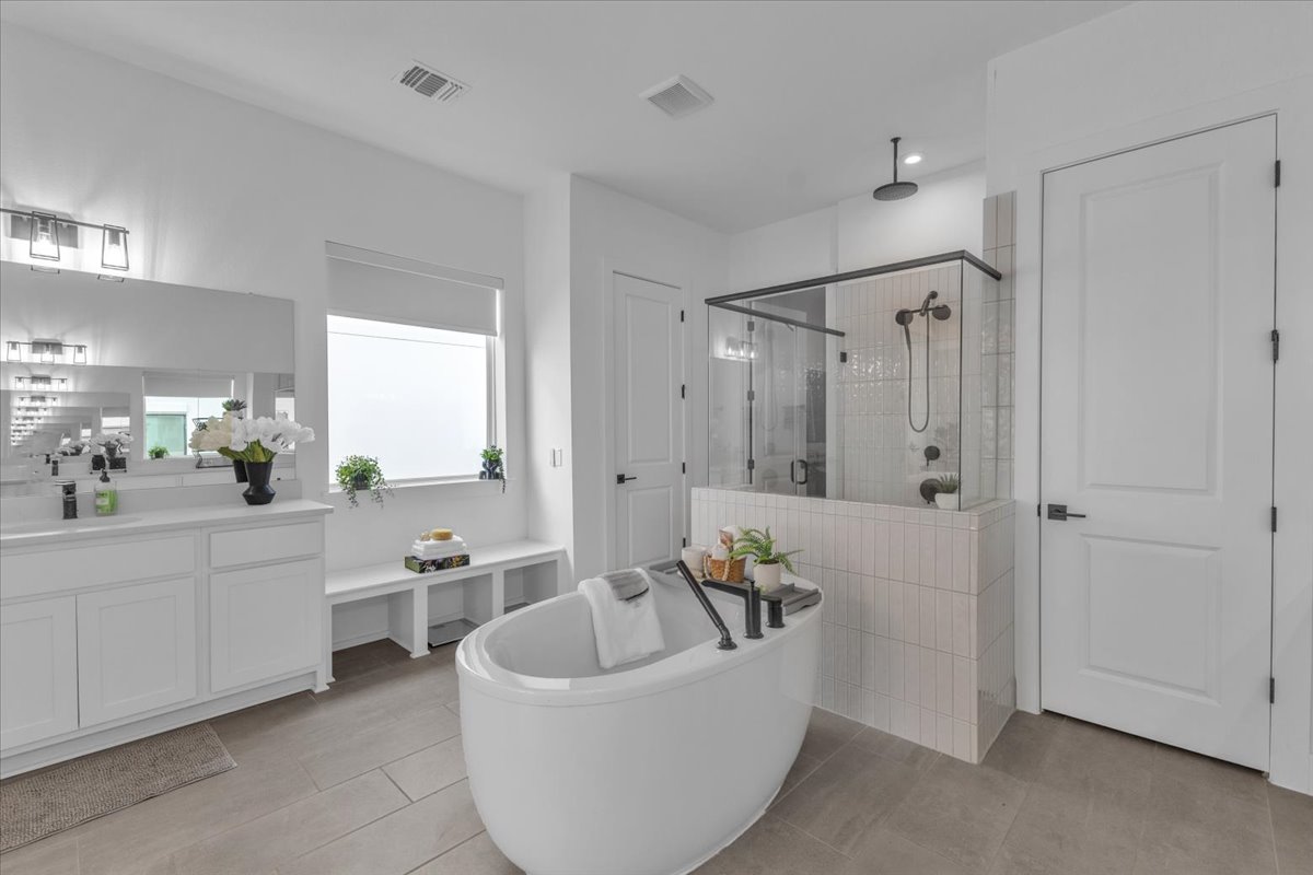 2312 Mondello Path Leander, TX 78641 - Photo 18 of 40 a bathroom with a tub a sink and mirror