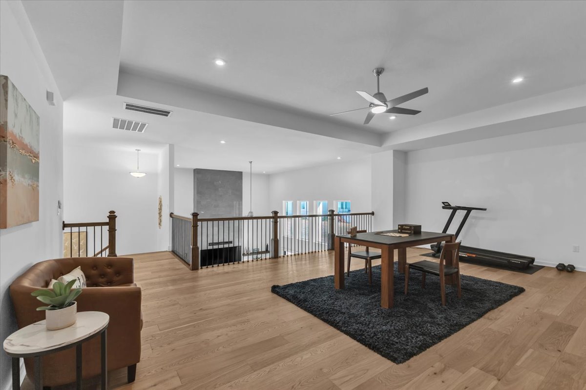 2312 Mondello Path Leander, TX 78641 - Photo 28 of 40 a living room with furniture a table and wooden floor