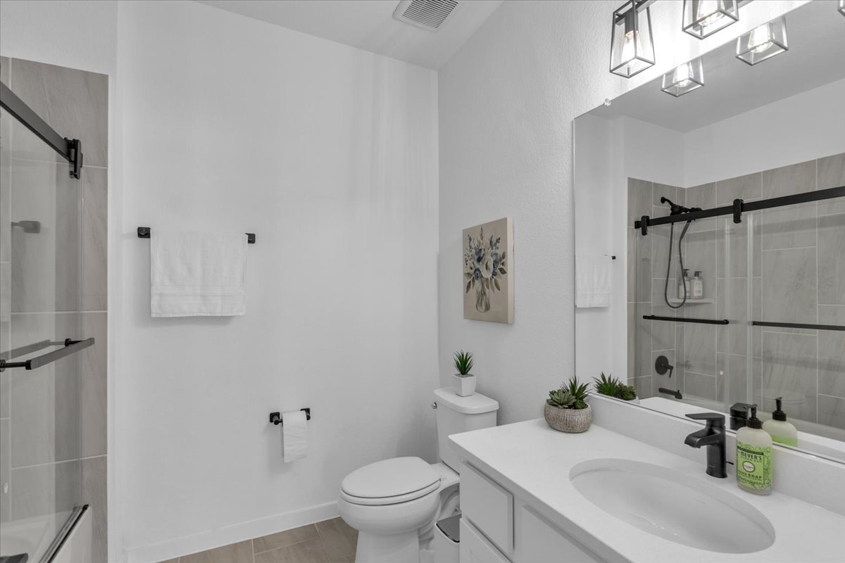 2312 Mondello Path Leander, TX 78641 - Photo 32 of 40 a bathroom with a sink toilet and shower