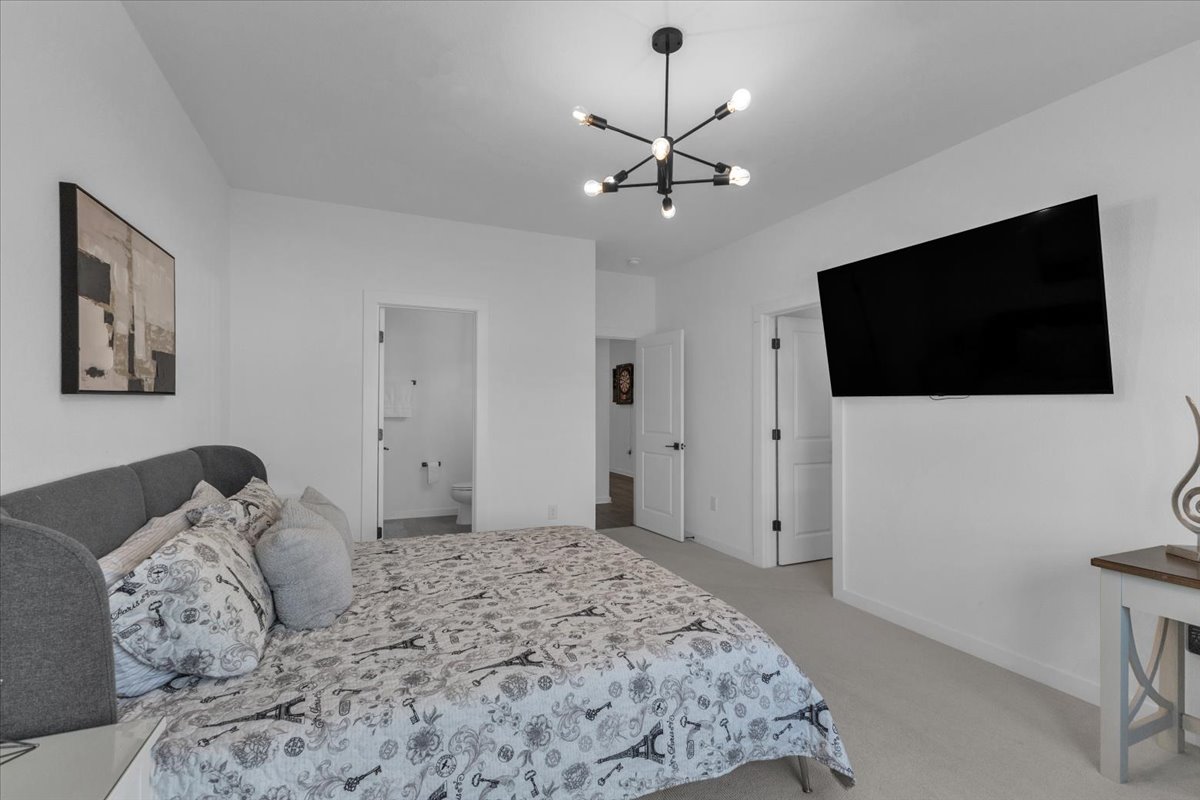 2312 Mondello Path Leander, TX 78641 - Photo 33 of 40 a bedroom with a large bed and a flat screen tv