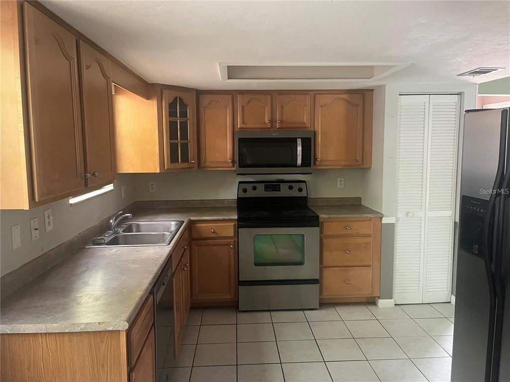 2024 Southwest 73rd Terrace Gainesville, FL 32607 - Photo 2 of 9 a kitchen with a refrigerator sink and microwave