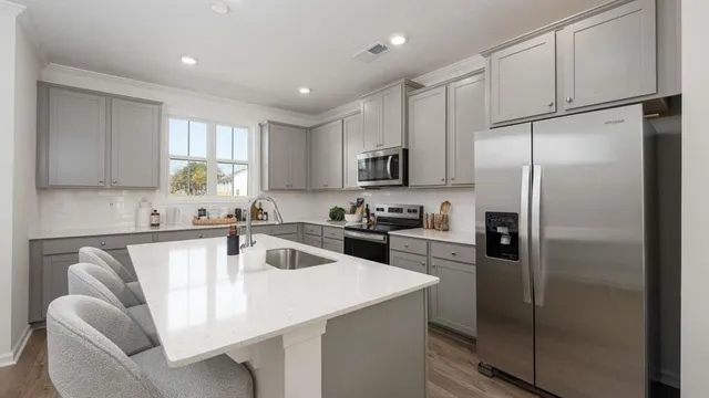 a kitchen with a sink stove top oven and cabinets