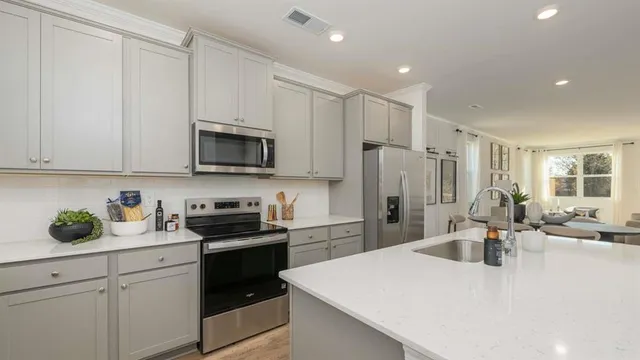 a kitchen with cabinets appliances and a window