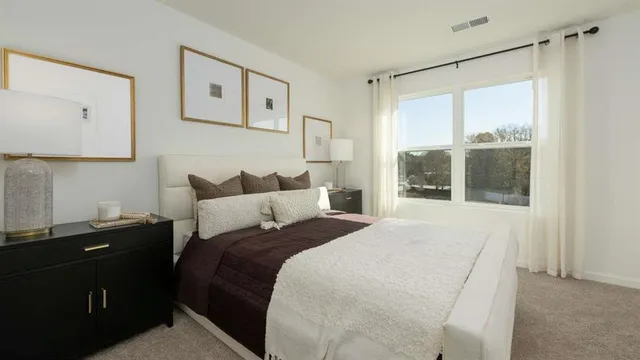 a bedroom with a bed and lamp