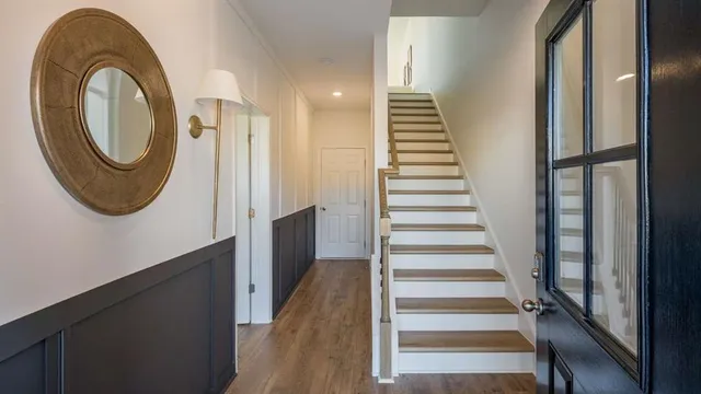 a view of a hallway with wooden floor and a large window