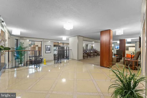 a lobby with furniture and floor to ceiling window