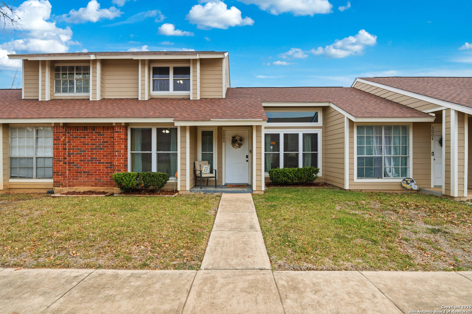 9140 Timber Path, Unit 3003 San Antonio, TX 78250 - Photo 1 of 38 front view of a brick house with a yard