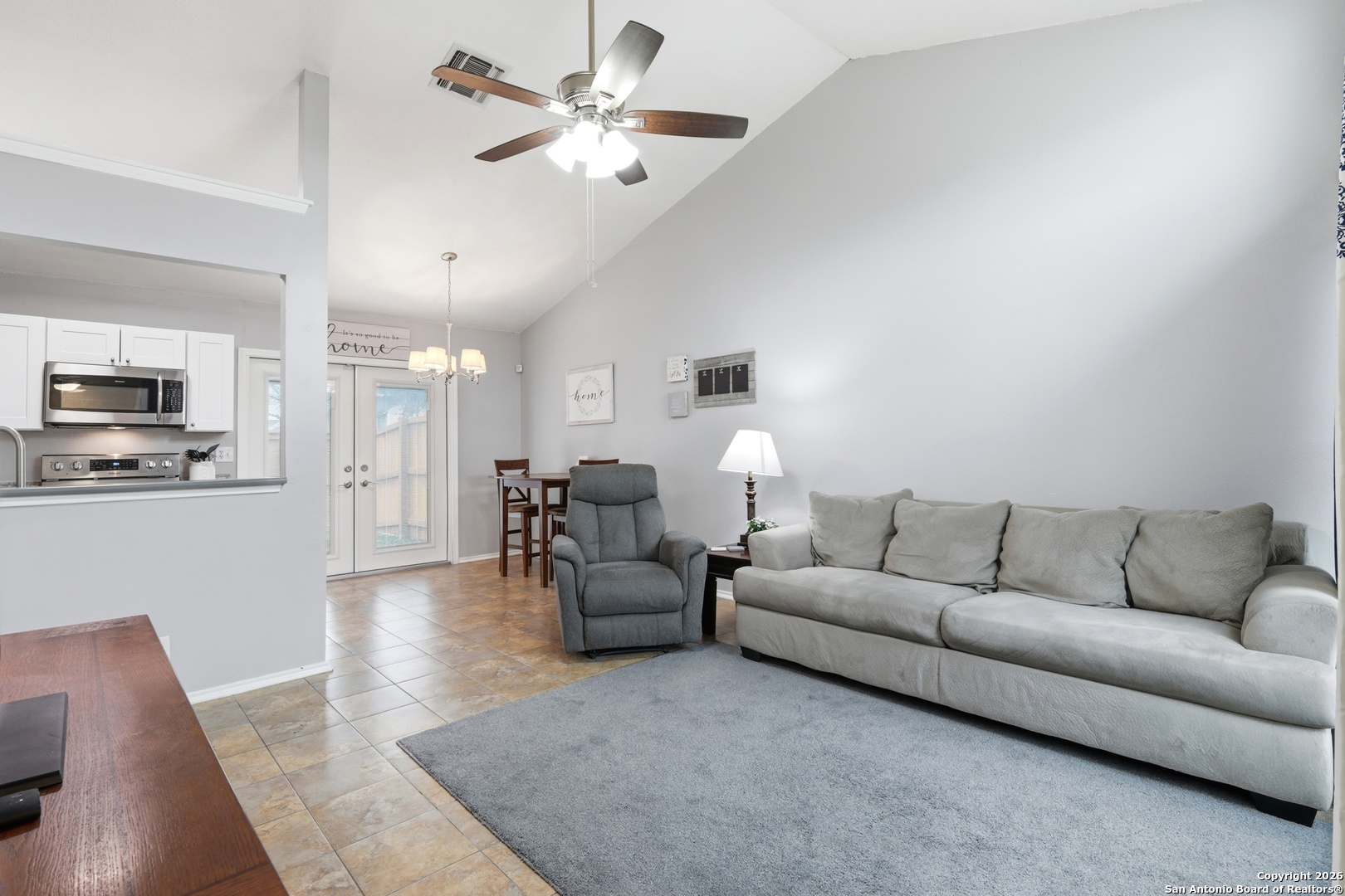 9140 Timber Path, Unit 3003 San Antonio, TX 78250 - Photo 11 of 38 a living room with furniture kitchen view and a chandelier