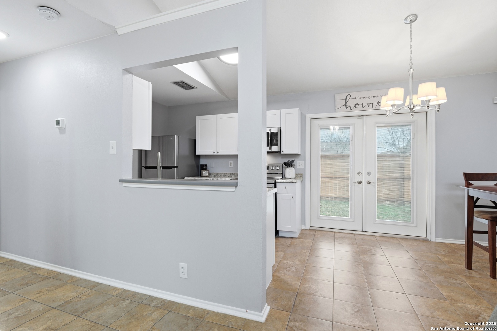 9140 Timber Path, Unit 3003 San Antonio, TX 78250 - Photo 13 of 38 a view of a kitchen with refrigerator and wooden floor