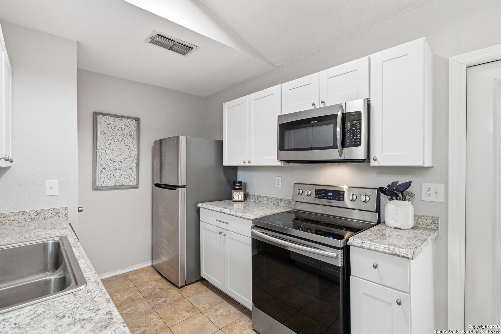9140 Timber Path, Unit 3003 San Antonio, TX 78250 - Photo 15 of 38 a kitchen with stainless steel appliances granite countertop a sink stove and microwave