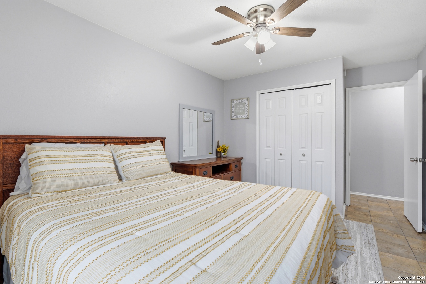 9140 Timber Path, Unit 3003 San Antonio, TX 78250 - Photo 19 of 38 a bedroom with a bed and a chandelier