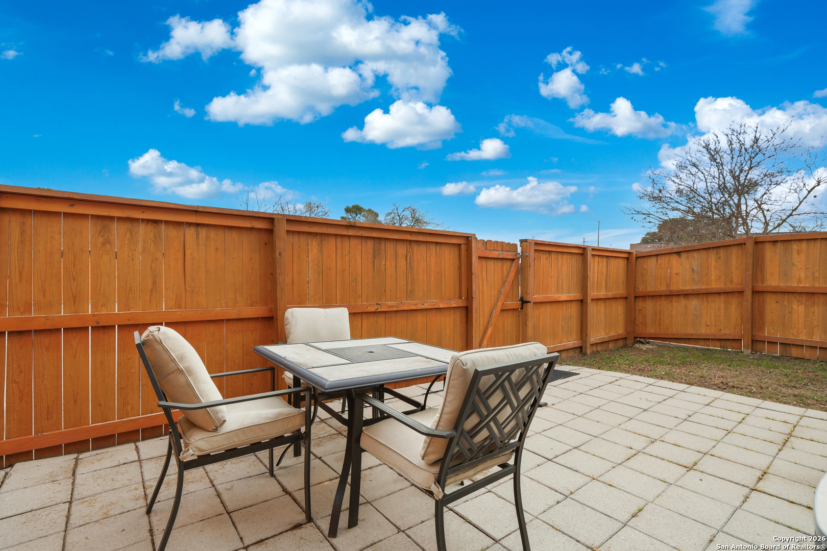 9140 Timber Path, Unit 3003 San Antonio, TX 78250 - Photo 26 of 38 a view of a chairs and table in a backyard