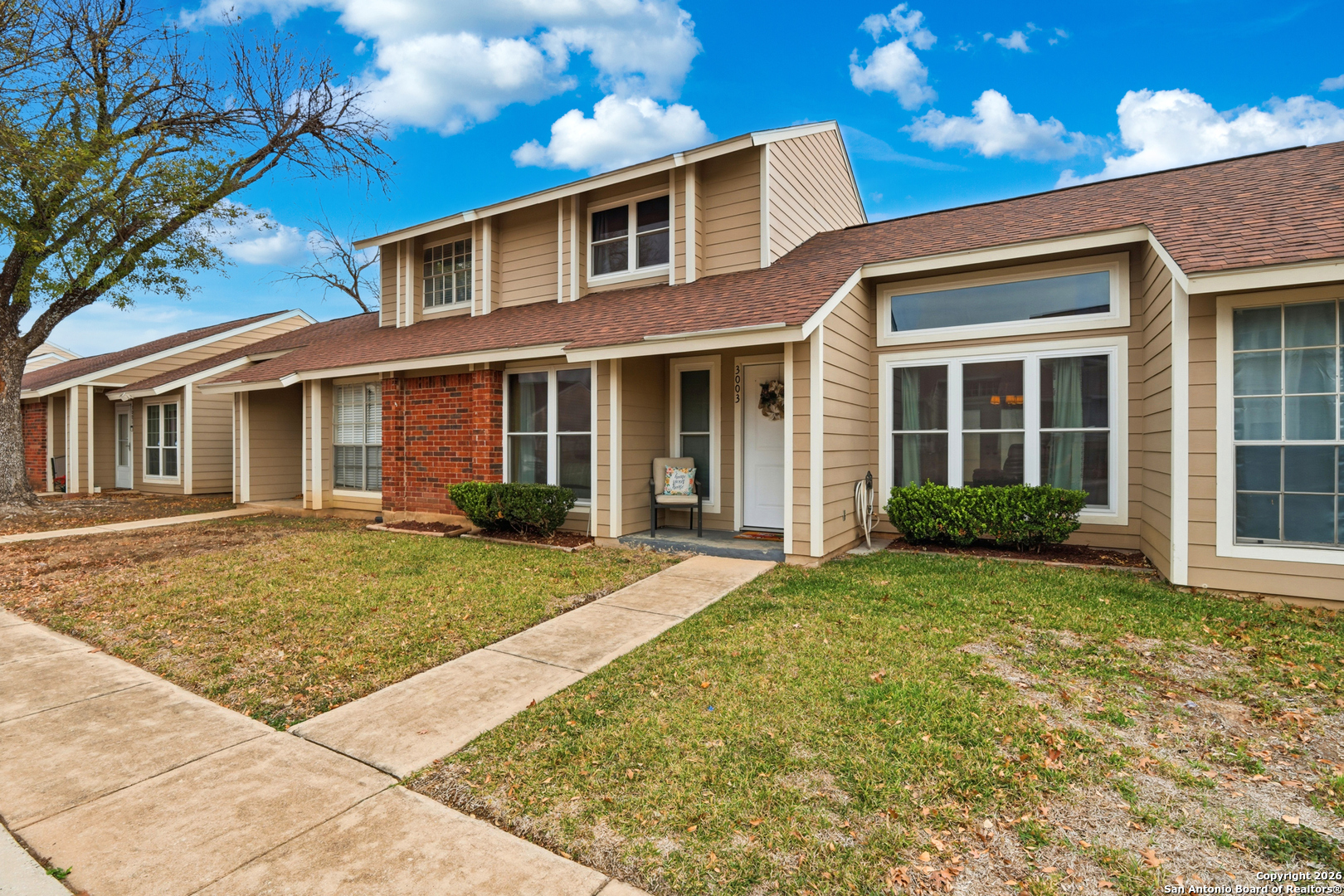 9140 Timber Path, Unit 3003 San Antonio, TX 78250 - Photo 8 of 38 front view of a house with a yard