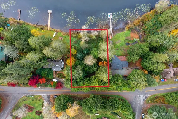 an aerial view of a house with a yard lake house and outdoor seating