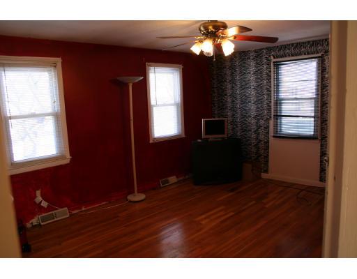 29 Lively Lane Springfield, MA 01109 - Photo 4 of 10 a view of an empty room with window and wooden floor