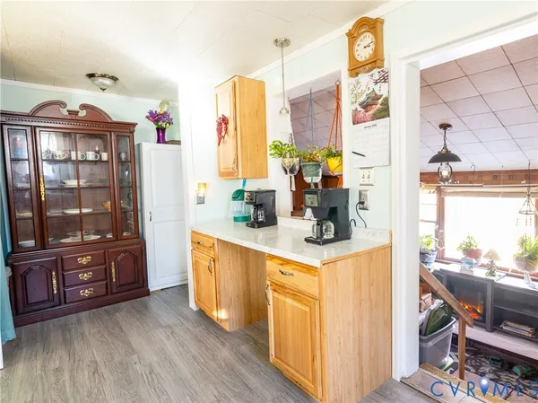 a kitchen with stainless steel appliances granite countertop a refrigerator a stove and a dining table with wooden floor