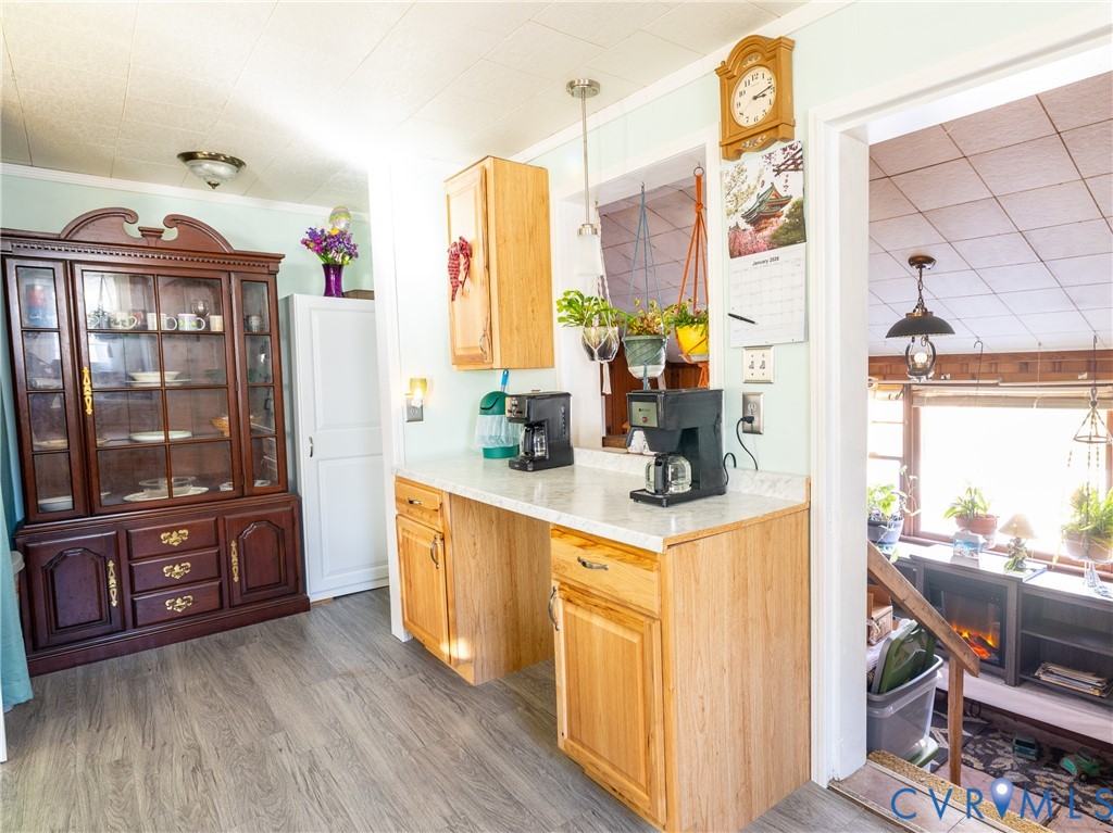 515 Ruthers Road Richmond, VA 23225 - Photo 11 of 34 a kitchen with stainless steel appliances granite countertop a refrigerator a stove and a dining table with wooden floor